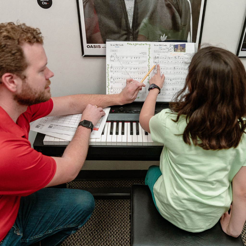 Student taking piano lessons with teacher at Mason Music